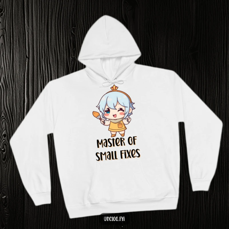 Funny hoodie illustration of a cheerful character using a small paintbrush for art touch-ups, expressing dedication and artistic happiness.